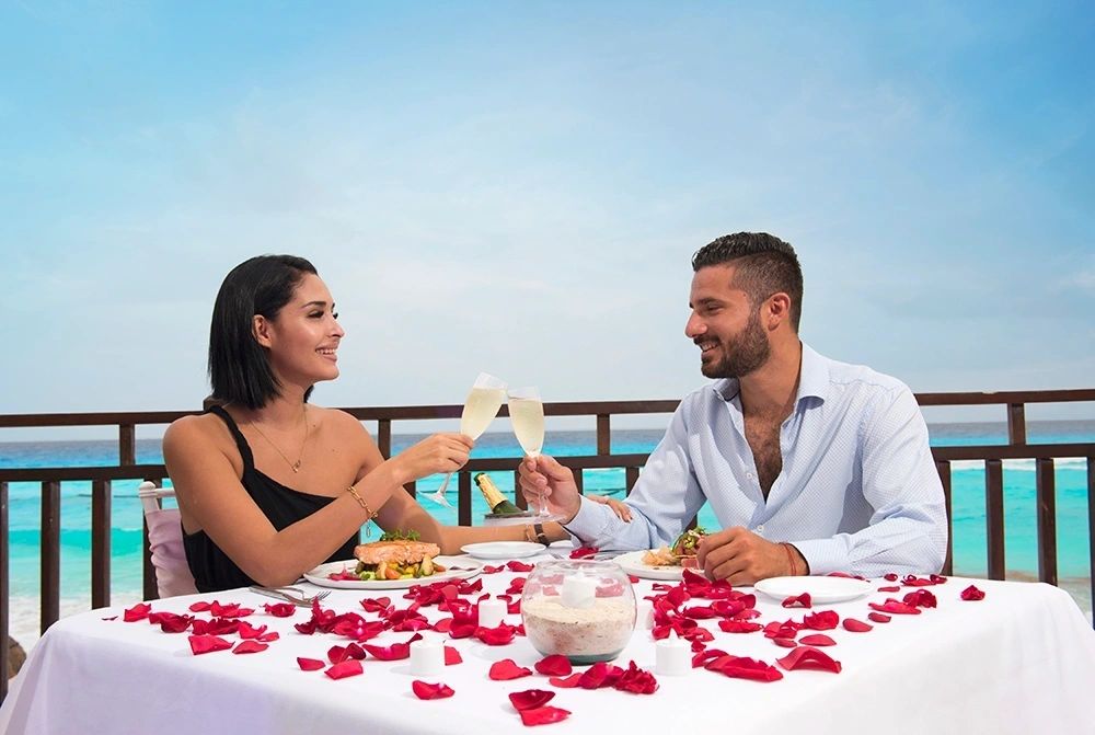 Couple sharing a romantic meal overlooking the ocean