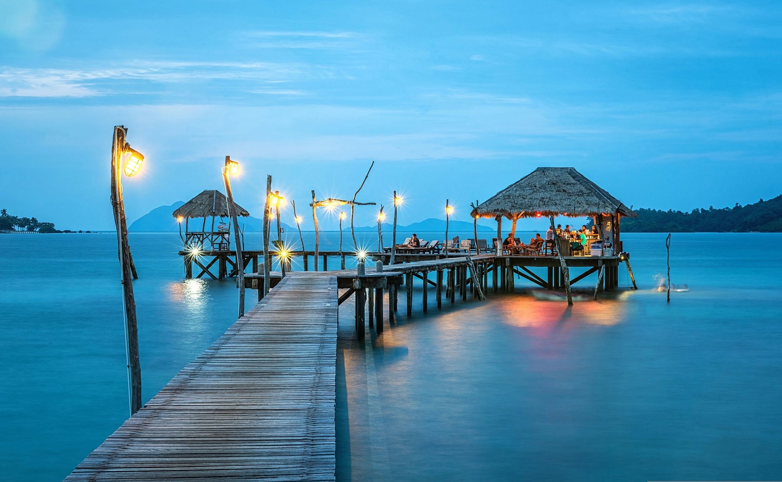 Illuminated overwater restaurant at dusk