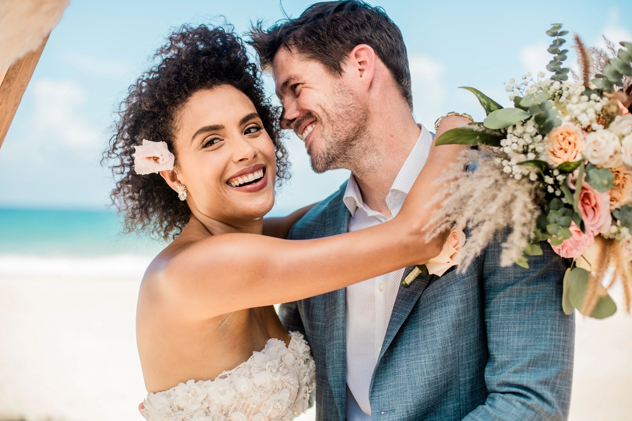 Newlyweds embracing beside a tropical pool