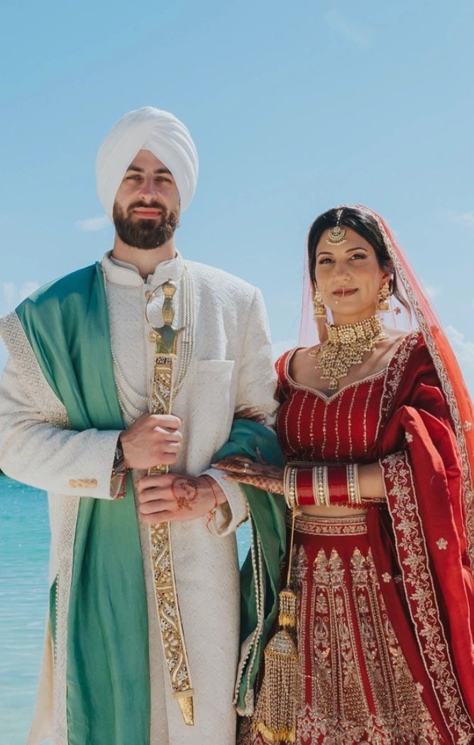 Couple wearing colourful South Asian wedding attire