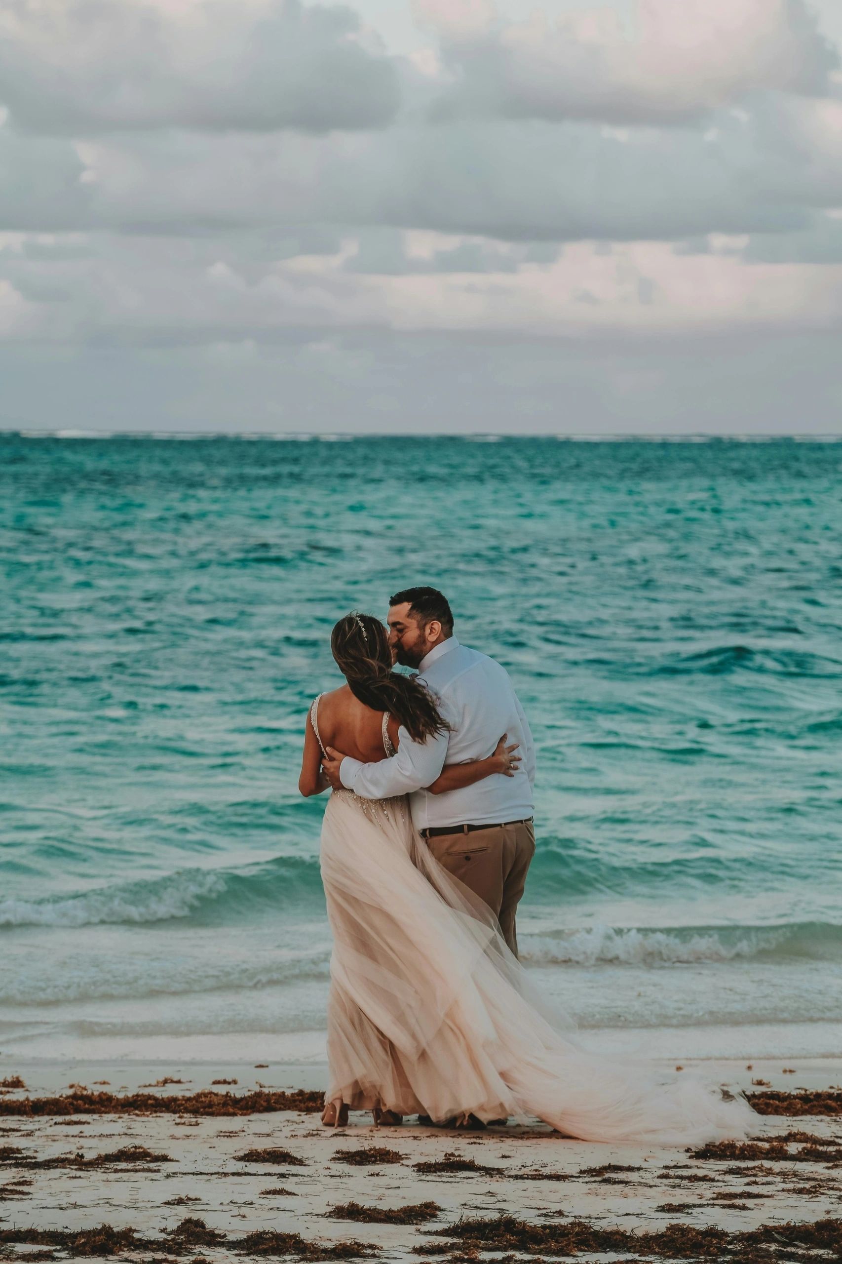 Couple embracing at the water's edge
