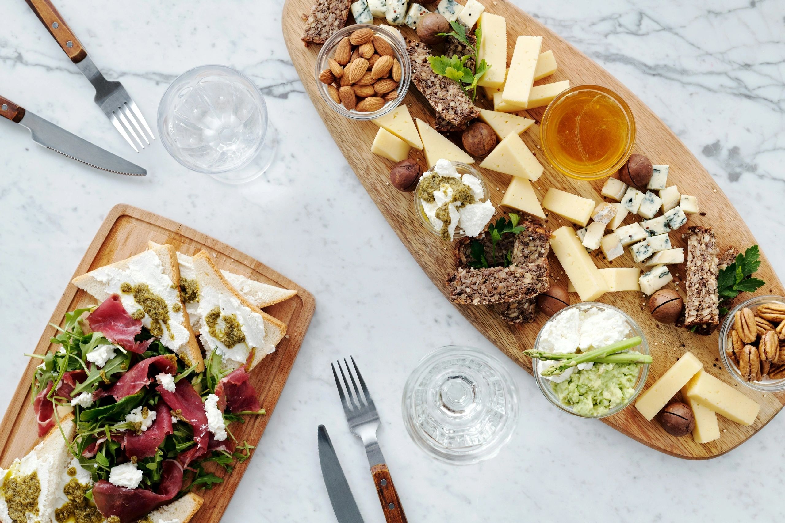 Platters of sandwiches and fruit on a table