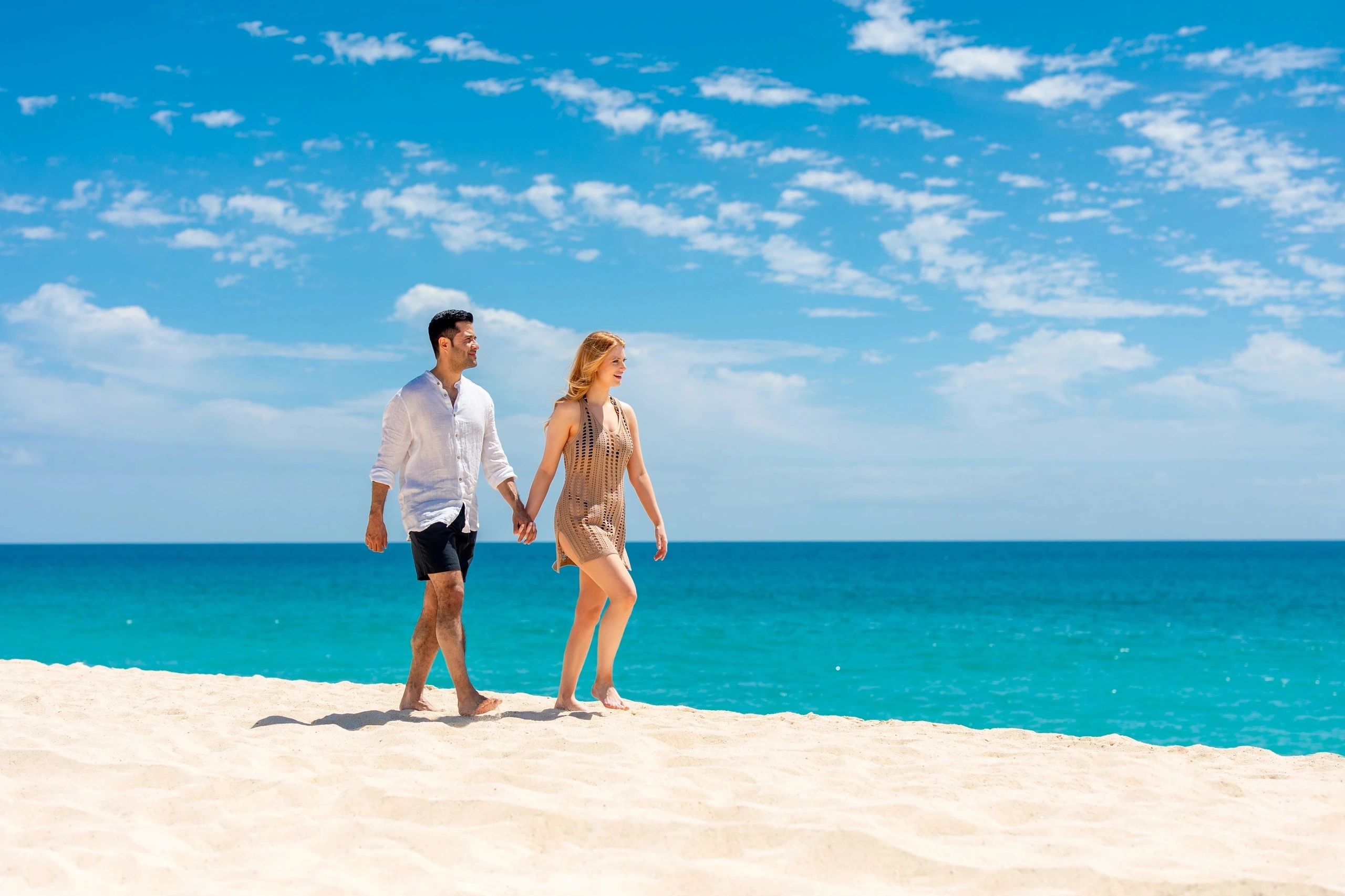 Couple doing a beach walk at Zoëtry Wellness & Spa Resorts