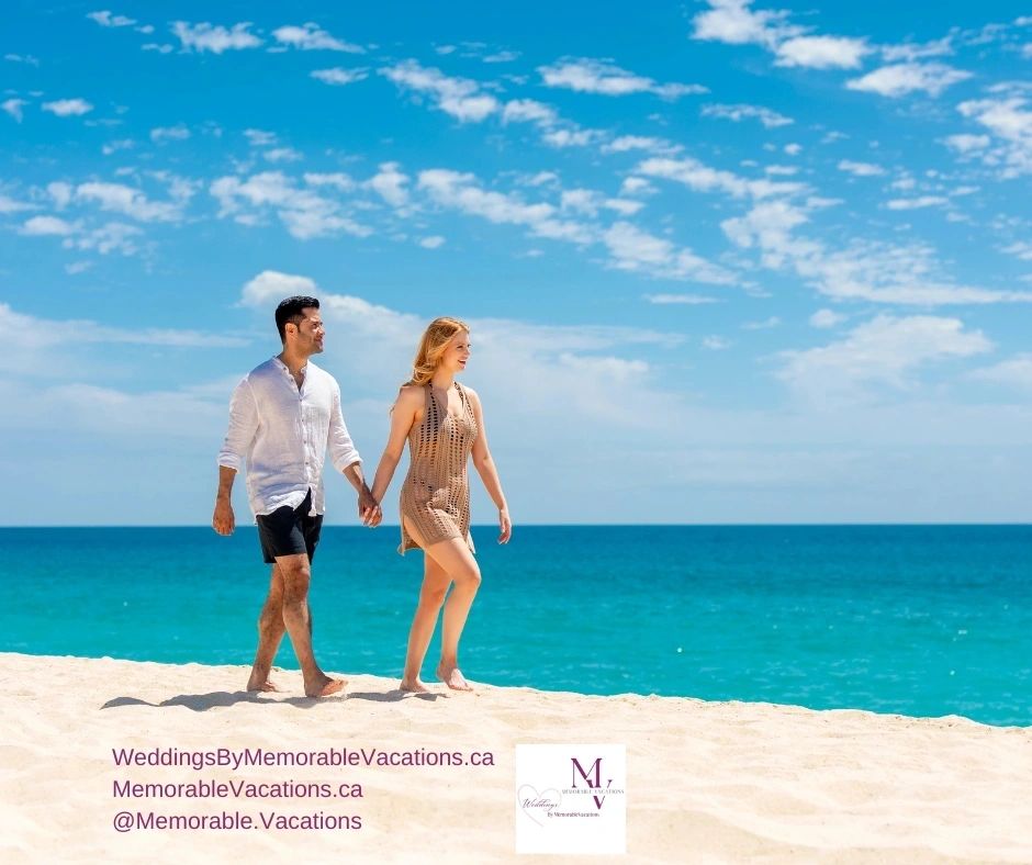 Couple walking along a bright turquoise shoreline