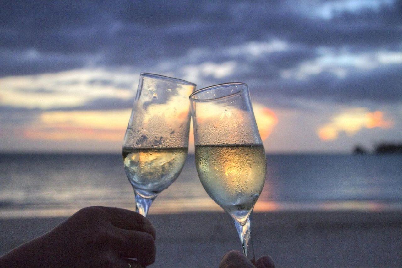 Toasting champaign on a beach with ocean view