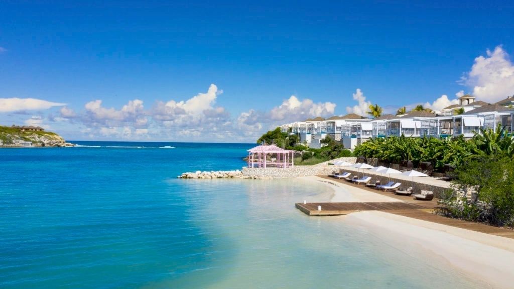 Resort beach and villas beside a turquoise bay