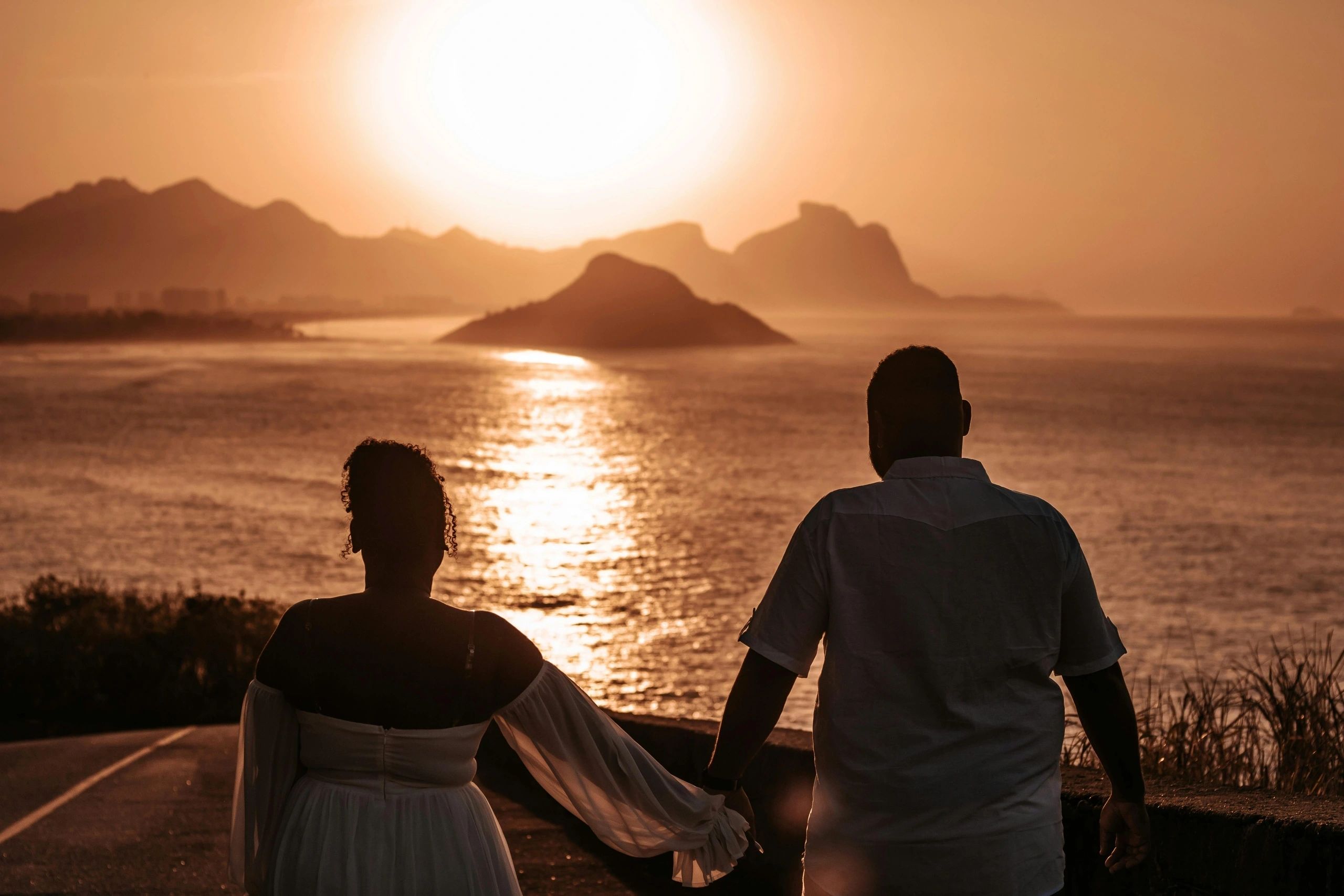 Couple watching the sunset over the ocean