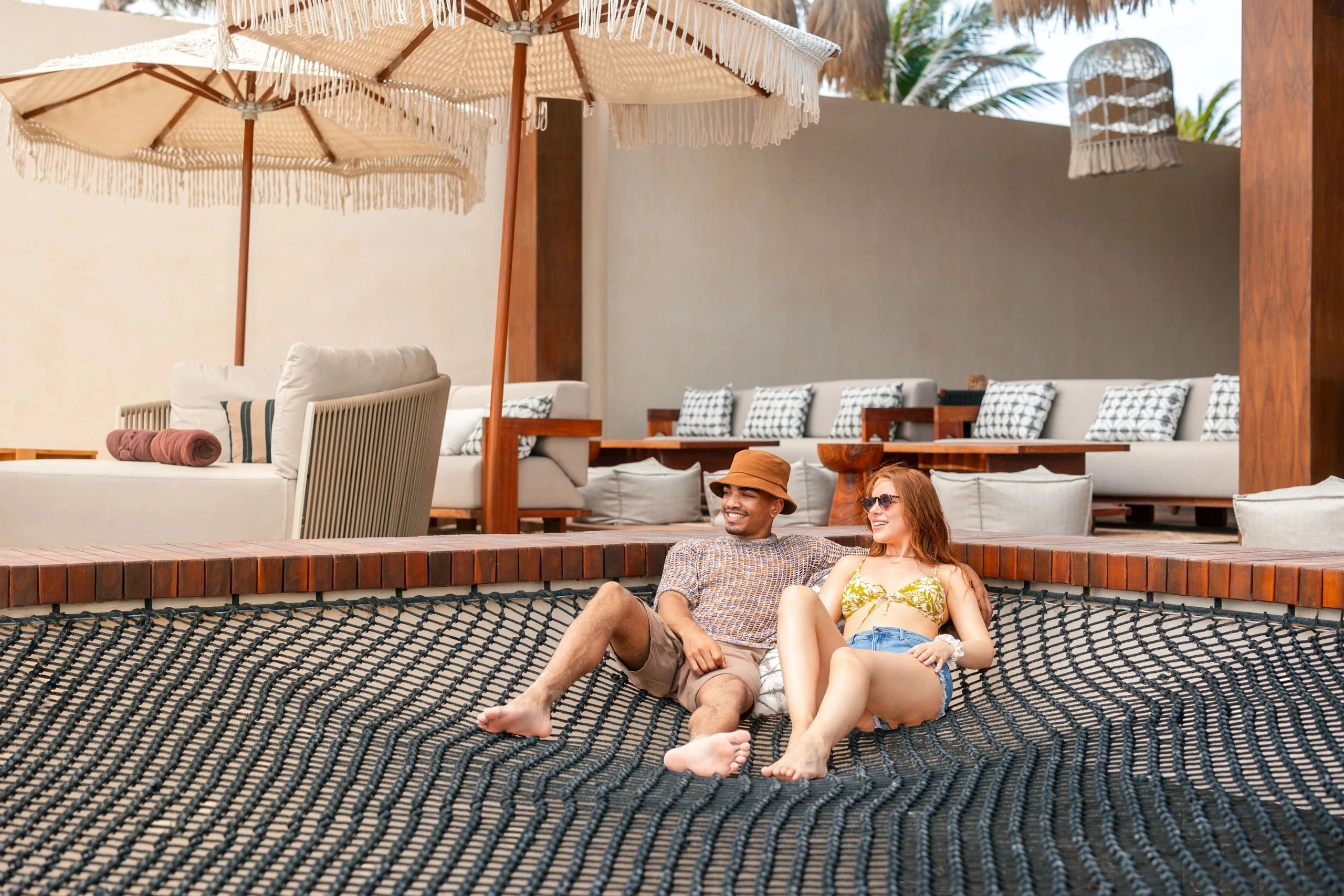 Couple relaxing on a cushioned resort daybed