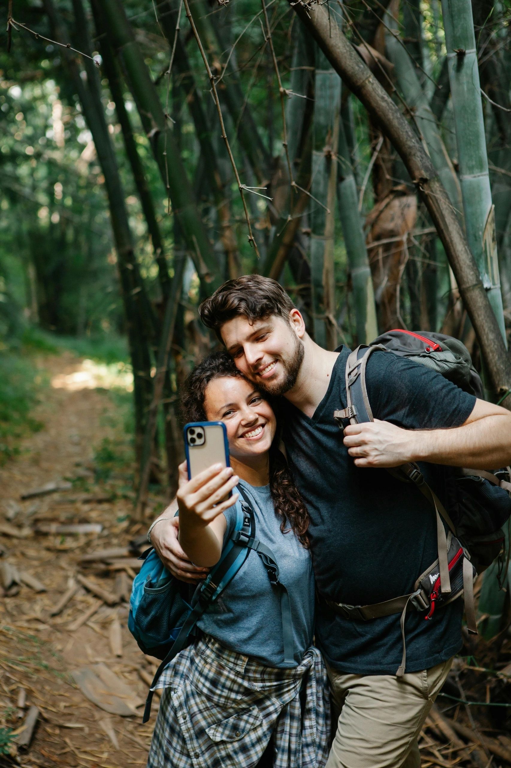 Couple embracing in a green woodland