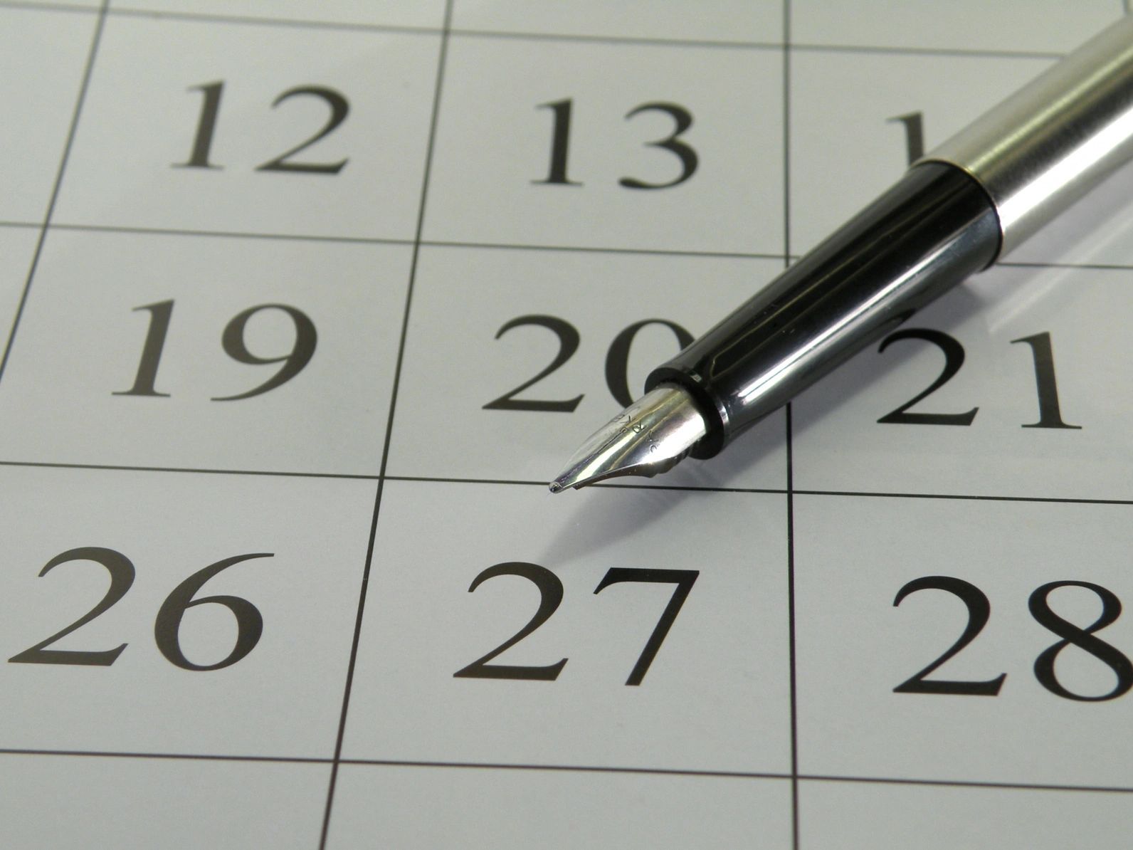 Calendar and pen for planning wedding dates