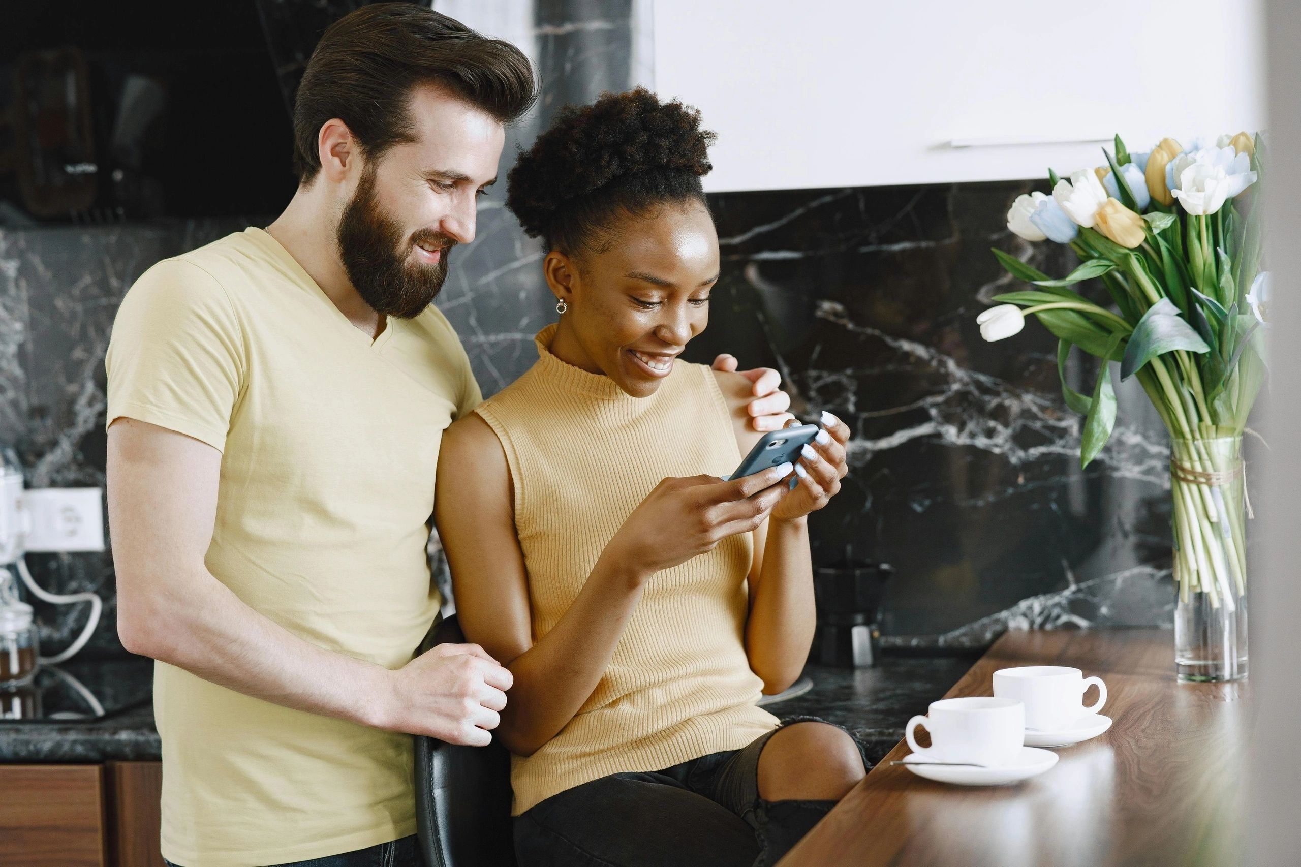 Couple looking at a phone together at a table