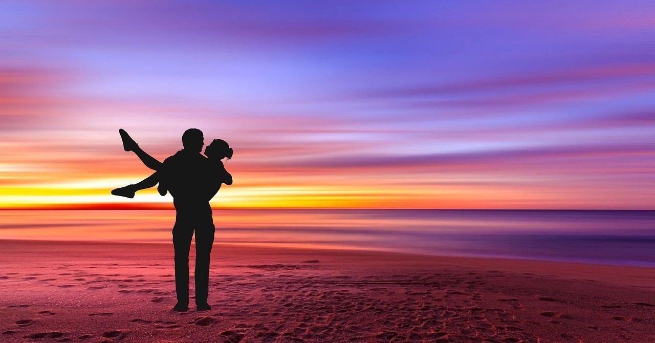 Honeymoon Couple on the beach for a romantic sunset