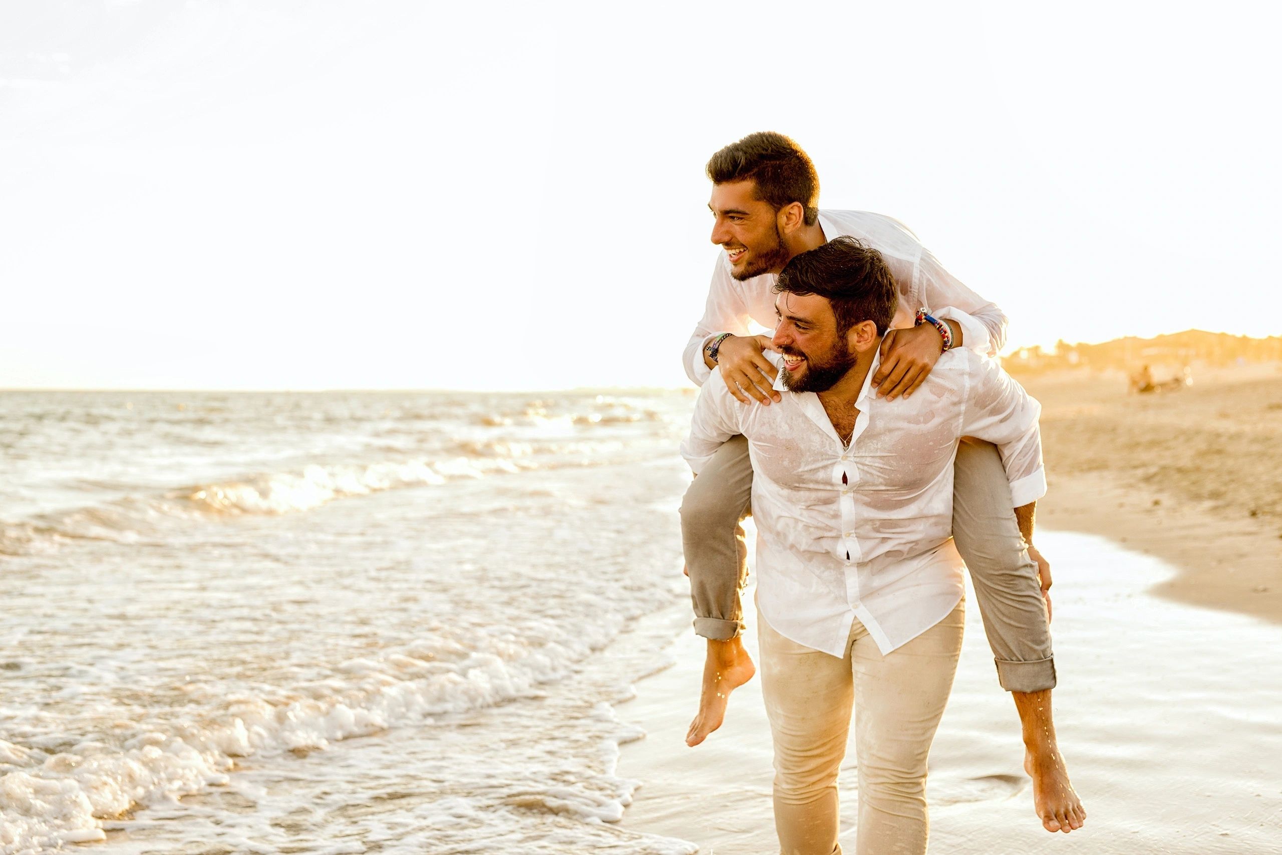 Couple laughing together in the shallow surf