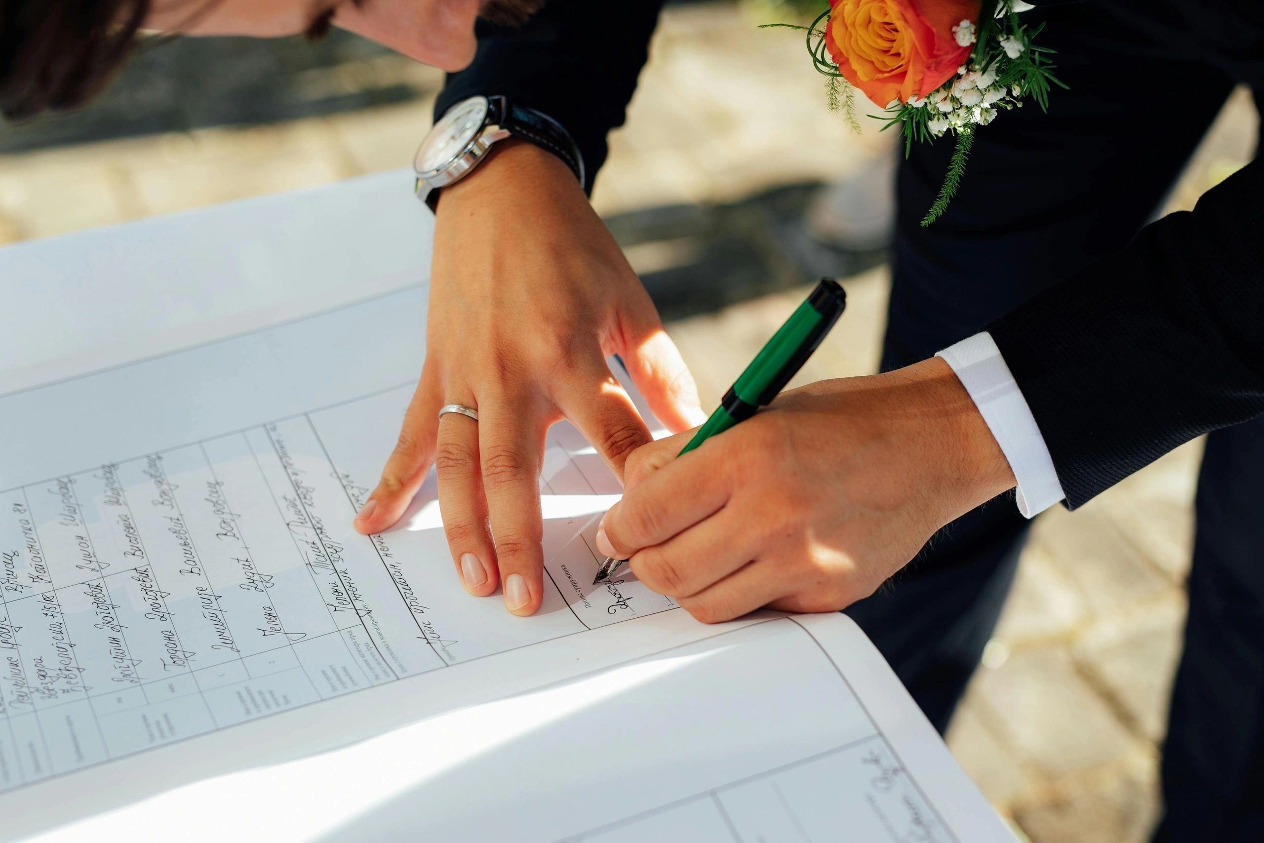 Couple signing wedding paperwork